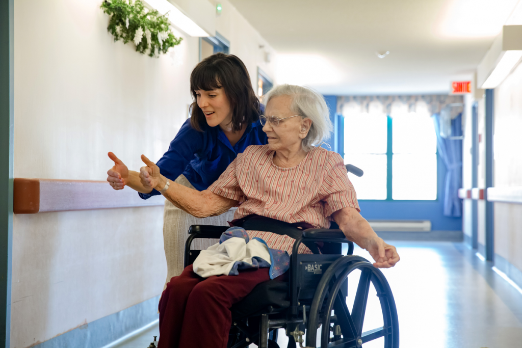 A dancer interacting with a resident of a retirement house